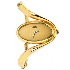 "This Vintage 1980s Girard Pearragaux solid gold bangle watch. This collectible Vintage piece is crafted in highly polished 18K Yellow Gold, weighing 77.0 grams and measuring 6\" around the wrist. An inversed oval, wave bangle watch, with a unique and elegant look. The inner movement is the Chopard brand. Secured with a hinged insert clasp. Hallmarked & Numbered: 51383 and 5047-1 In excellent condition This purchase is accompanied by a professional appraisal document." Gold Bangle Watch, Solid Gold Bangle, Chanel Perfume, Bangle Watches, Gold Armband, Jewelry Appraisal, Jewelry Lookbook, Gold Bangle, Gems Jewelry