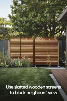 a wooden screen is in the middle of a yard