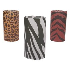 three different types of animal print lampshades on a white background, one is red and the other is black