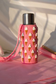 a pink water bottle with ice cream cones on it