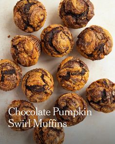 chocolate pumpkin swirl muffins sitting on top of a white surface with the words, chocolate pumpkin swirl muffins