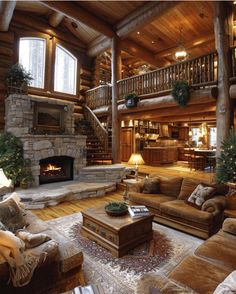 a living room filled with furniture and a fire place in the middle of a wooden floor