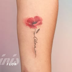 a single red flower with the word love tattooed on it's side arm and behind its ear