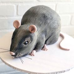 a cake shaped like a rat sitting on top of a table