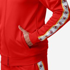 A jacket that you'll be jacked up to wear. Bundle up for your jog around the block with this Kansas City Chiefs Stripe Logo Track Jacket. Features All-over team-colored design so you can rep the team in style Embroidered team logo display on left chest, in case there were any doubts where your allegiances lie Stripe accents on sleeves with repeat team logo displays for a little extra team spirit Zip-up structure so you can zip up and party down Long sleeves so you can stay warm, even on the chil Team-colored Outerwear With Team Name For Sports Events, Team-colored Outerwear With Team Name For Sports Season, Team-colored Outerwear With Team Name For Game Day, Team-colored Outerwear For Game Day With Team Spirit, Team-colored Outerwear For Game Day, Team Outerwear For Sports Season, Team-colored Varsity Jacket For Sports Season, Sporty Game Day Outerwear With Team Name, Team-colored Long Sleeve Track Jacket For Game Day