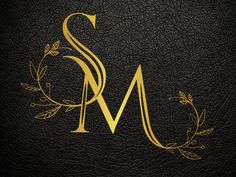 the letter s and m is made up of gold letters on black leather with leaves