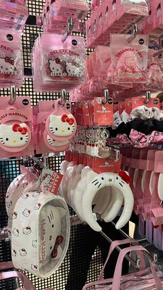 many hello kitty items are on display for sale in a store with pink and white accessories