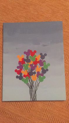 a painting of a tree with hearts painted on the leaves and in the background is a gray sky