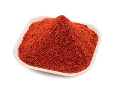 red powder in a white bowl on a white background