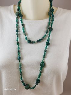 This necklace is one of my specialties.  It is a mixed lot of deep green natural stones.  There are emerald chips, green aventurine, Pearls, Ruby Zoisite, Chrysocolla, Swarovski Bicone crystals, Jade, all strung in a random fashion. It is strung on nylon fishing line, making it very strong.  There is no clasp, just wrap and go, Green Polished Bead Gemstones For Gifts, Green Necklaces With Round Beaded Stones, Green Jade Crystal Necklace With Natural Stones, Green Emerald Necklace For Jewelry Making, Green Emerald Bohemian Necklace, Green Malachite Gemstone Bead Necklaces, Green Moss Agate Round Bead Necklaces, Green Malachite Gemstone Beads Necklace, Spiritual Green Beaded Necklaces With Natural Stones