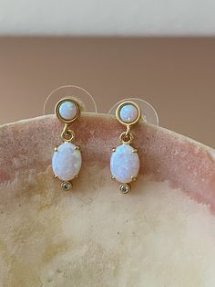 "Opal Earrings, Opal Drop Earrings, Gold Opal Earrings, October Birthstone, October Earrings, Birthstone Earrings, Opal Jewelry, Opals, Opal Beautiful flashy & dainty Opal drop earrings that will add a little glam to your everyday! DETAILS: * 14KT gold over brass * Nickel free * Synthetic Opal + Cubic Zirconia stones * Length: .75\" (17mm) Let's connect! Instagram: @mysticajewelry Facebook: @mysticajewelry Website: mysticajewelry.com All of our jewelry is designed and hand made with love in our Gold Teardrop Earrings With Stones, Single Opal Earring As A Gift, White Opal Earrings For Pierced Ears, Opal Drop Earrings For Wedding, White Opal Drop Earrings, Oval Stone Earrings Gift, Oval Stone Earrings For Gift, October Earrings, Opal Drop Earrings