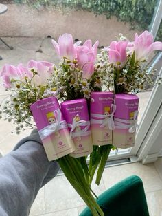 pink flowers and baby's breath wrapped in white ribbon