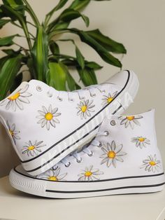 "-🌼DAISY DESIGN🌼- 🌈DESCRIPTION: You will receive a unique pair of shoes which I will personally paint by hand just for you.  I create your shoes from scratch by hand in my little studio. The main design is painted on the outside of the shoes only, while on the inside the shoes are painted with the same minimalist decorations to match with the outside. 🔥UNIQUE: As the shoes are PAINTED BY HAND, the design may slightly vary from the picture. Each design is unique in its own way. 🎨CUSTOMISE THEM: As the shoes are made to order, feel free to make them even more unique. In fact it is possible to customise them, adding a text, a date or a name on the inside of the shoes or even in the corner, on the outside next to the characters. Simply leave me a note at the checkout with the details you Hand Painted White Custom Sneakers For Summer, Hand Painted White Low-top Canvas Shoes, Artsy Hand Painted White Custom Sneakers, White Hand Painted Low-top Canvas Shoes, Artistic White Canvas Sneakers, White Hand Painted Canvas Shoes With Round Toe, Hand Painted White High-top Custom Sneakers, Artistic White Sneakers For Spring, White Hand Painted High-top Custom Sneakers