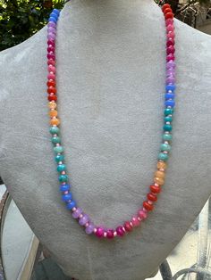 Embrace the vibrant energy of the rainbow with the Rainbow Radiance Chakra Necklace. This eye-catching piece features a gradient of colorful beads, each corresponding to one of the seven chakras. Designed to balance your energy centers, this necklace is not only a beautiful accessory but also a powerful tool for spiritual alignment and healing. Wear it to infuse your day with positivity and harmony. Materials: Mixed gemstones (Amethyst, Carnelian, Aventurine, and more) Length: 20 inches Closure: Toggle clasp Adjustable Rainbow Necklace With Colorful Beads, Iridescent Adjustable Necklace With Round Beads, Iridescent Adjustable Round Bead Necklaces, Rainbow Faceted Round Bead Necklaces, Spiritual Multicolor Beaded Necklaces For Meditation, Multicolor Spiritual Long Beaded Necklaces, Spiritual Multicolor Beaded Necklace For Meditation, Rainbow Necklaces With Polished Round Beads, Adjustable Rainbow Beaded Necklace