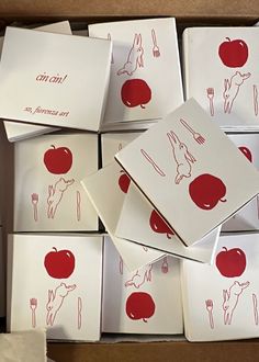 there are many red and white cards in the box that have drawings of food on them