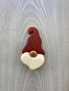 a gnome's hat is mounted on the side of a wooden wall or door