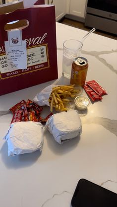 some food is sitting on a table next to a cell phone and a red bag