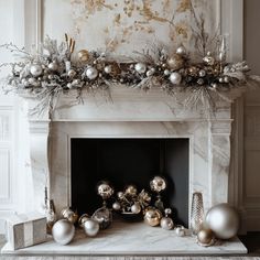 a fireplace decorated with silver and gold ornaments