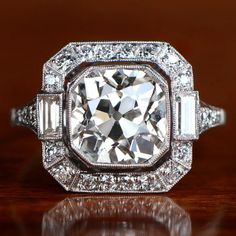 an antique style diamond ring with baguetts and side stones