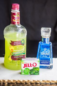 three different types of alcohol sitting on a table next to each other, including lemonade and jello