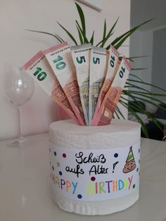 a birthday cake with money in it on a table