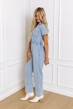 Jump into trendy style with this denim jumpsuit! Unlined denim material - A collared v-cut neckline that goes into a button-up bodice - Short sleeves - A functional chest pocket - A waistline with an elastic back, belt loops, a hidden zip fly, and button closure - Functional side and back pockets - A relaxed silhouette that ends in ankle length hemlines Medium Wash Short Sleeve Jumpsuit With Button Closure, Medium Wash Button-up Denim Jumpsuit, Trendy Light Wash Jumpsuits And Rompers For Spring, Short Sleeve Denim Jumpsuits And Rompers With Button Closure, Medium Wash Denim Jumpsuit With Pockets, Light Wash Cotton Jumpsuit With Pockets, Medium Wash Cotton Denim Jumpsuit With Button Closure, Casual Light Wash Denim Jumpsuit, Light Wash Cotton Jumpsuits And Rompers With Pockets