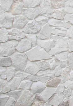 an image of a white stone wall that looks like it has been made out of rock