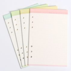 five notebooks lined up on top of each other with holes in the front and back