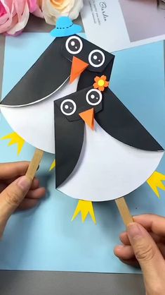 someone is making a penguin out of paper