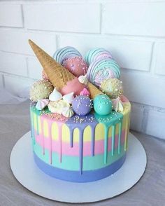 a colorful cake with ice cream and candy on top