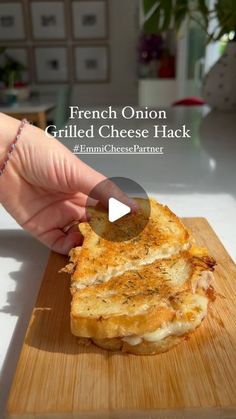 the french onion grilled cheese hack is being held up by a woman's hand