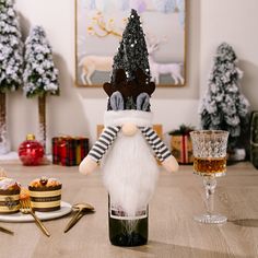 a wine bottle that is sitting on a table next to some food and drink glasses