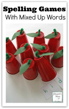 a group of red plastic cups with green paper on them and the title spelling games with mixed up words