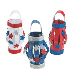 three paper lanterns with red, white and blue stars on them are shown in the shape of buckets