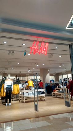 the inside of a clothing store with clothes on display