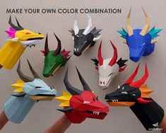 a hand is holding an origami dragon head with different colors and sizes on it