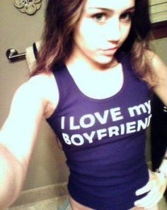 a woman with long hair wearing a tank top that says, i love my boyfriend