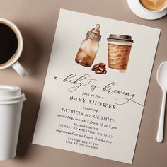 a baby shower is set up next to a cup of coffee