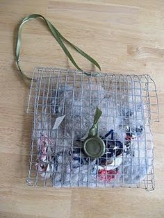 a metal cage holding various items on top of a wooden floor