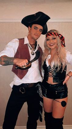 a man and woman dressed in pirate costumes