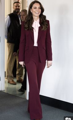 a woman in a red suit and pink shirt