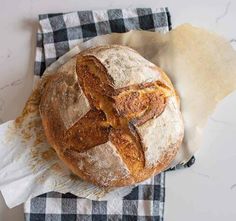 a loaf of bread sitting on top of a checkered napkin