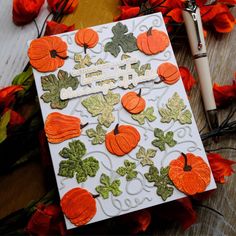 a card with pumpkins and leaves on it