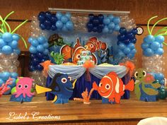 an under the sea themed birthday party with balloons, decorations and balloon fish on display