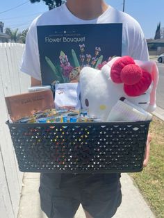 a man is holding a basket full of items for his daughter's flower bouquet