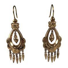 Victorian gold filled articulated long earrings in the Renaissance Revival taste. Gold filled metal has incised foliate motifs with two center hanging urns with small pendant drop fringes and french wire hooks. Excellent Condition. 1880's. L 1.3/4" x W 3/4" Victorian Style Ceremonial Dangle Earrings, Ornate Yellow Gold Chandelier Dangle Earrings, Ornate Yellow Gold Dangle Chandelier Earrings, Antique Gold Engraved Earrings, Antique Drop Earrings With Historical Design, Antique Ceremonial Dangle Earrings, Antique Dangle Earrings For Ceremonies, Antique Gold Chandelier Earrings, Ornate Yellow Gold Chandelier Drop Earrings