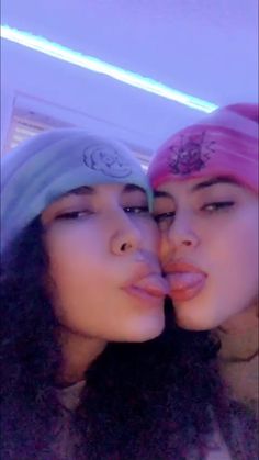 two young women with bandanas kissing each other