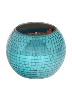 a blue mosaic vase sitting on top of a table