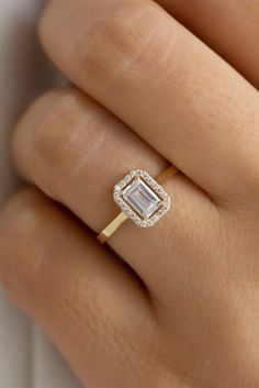 a woman's hand with a diamond ring on it