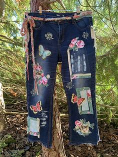 These pre-loved jeans started life as pair from Urban Jeans Co. size 14, NZ sizing. They are now an ankle length funky-boho-hippy designer pair created by me in my studio in New Zealand. Adorned with fabrics, lace, buttons and braids, featuring patches, butterflies and florals and stencils. Machine and hand sewn and have been washed after embellishing. Braided wool/cotton belt included. Please check my other listings for more up-cycled jeans. MEASUREMENTS Waist 35-36 in (89-91.5cm)  2 buttons fo Bohemian Spring Bottoms With Floral Patchwork, Spring Bohemian Bottoms With Floral Patchwork, Summer Festival Jeans With Patchwork, Summer Festival Patchwork Jeans, Spring Festival Patchwork Jeans, Bohemian Straight Leg Summer Jeans, Bohemian Straight Leg Jeans For Summer, Hippie Patchwork Jeans For Spring, Bohemian Jeans For Summer Festivals